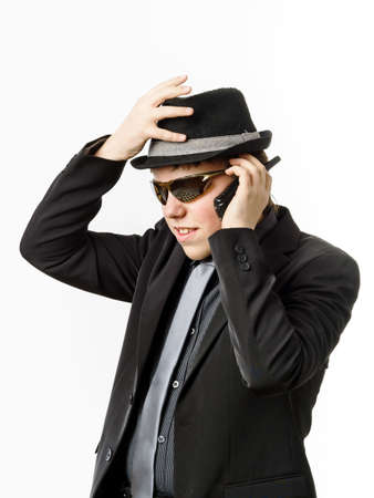 Teenage boy posing like a guardsman with radio transmitter, isolated on whiteの写真素材