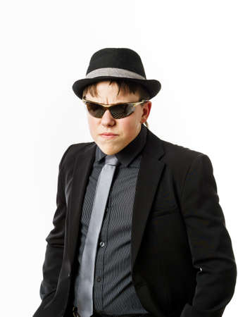 Expressive teenage boy dressed in suit isolated on white backgroundの写真素材