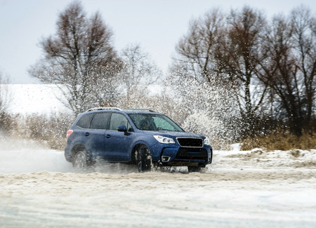 Powerful offroader car sliding by lake ice on winter sport traceのeditorial素材