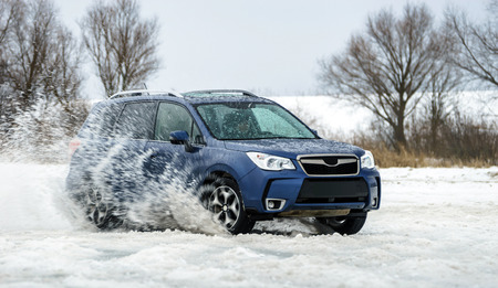 Powerful offroader car sliding by lake ice on winter sport traceのeditorial素材