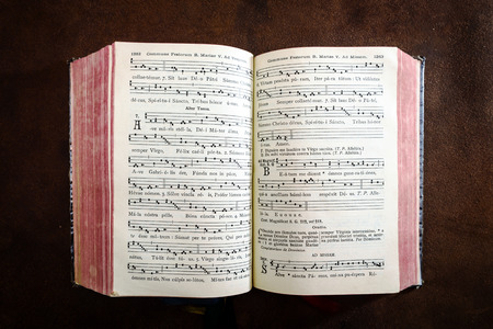 Vintage psalm book with chorus singing notes closeup
