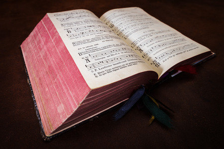 Vintage psalm book with chorus singing notes closeup