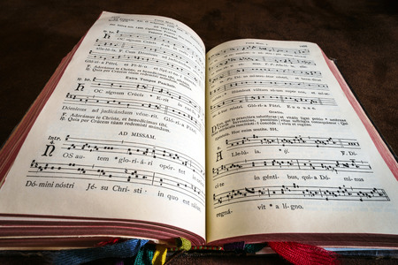 Vintage psalm book with chorus singing notes closeup