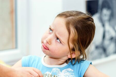 Cute little girl close-up indoor portrait, childhood conceptの写真素材