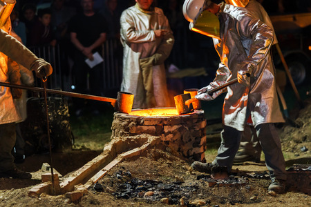 Classic technology of bell producing with melting steel in the ground. France.