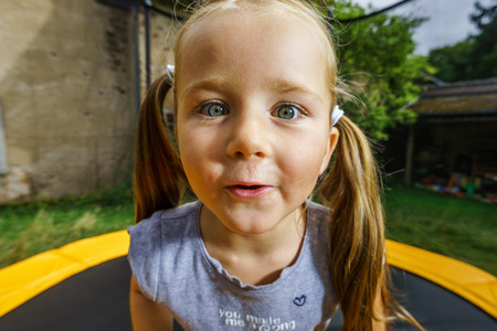 Cute little girl surprising face portrait, close-upの写真素材