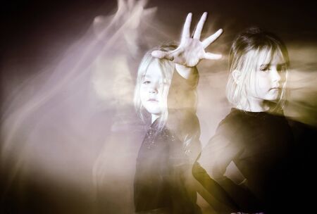 Halloween mystic photo with mixed light. Cute little girl multi-portraitの写真素材