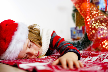 Cute little girl in red santa hat christmas portrait isolated on whiteの写真素材