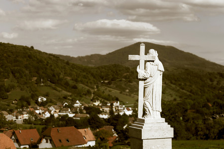 Majestic Jesus Christ sculpture over little french village, Maisonsgoutte, Franceの写真素材