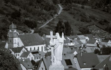 Majestic Jesus Christ sculpture over little french village, Maisonsgoutte, Franceの写真素材