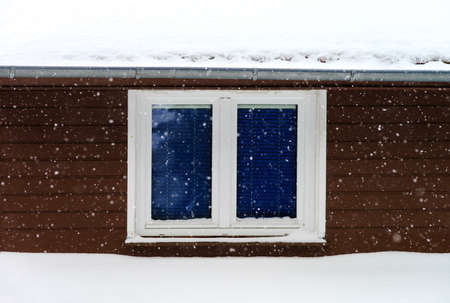 Beautiful snowflakes on window and wall background, flurry in countrysideの写真素材
