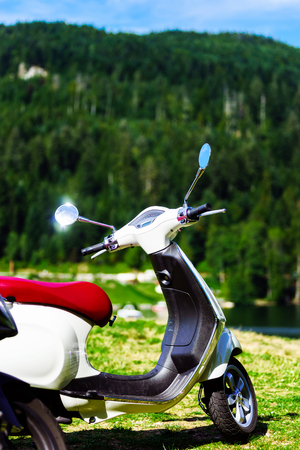 Old vintage scooter in nature place, french mountainsの写真素材