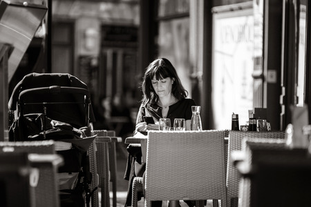 24th September 2016: Strasbourg, France. Summer day in the touristic center of Strasbourg. Mother with babycarrier in cafeのeditorial素材