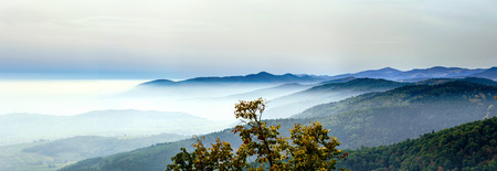 Beautiful mountains landscape from the top of the hill with fog, Alsace, France