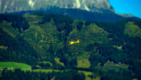 Rescue helicopter flying in the Alps, Austria, summertimeの写真素材