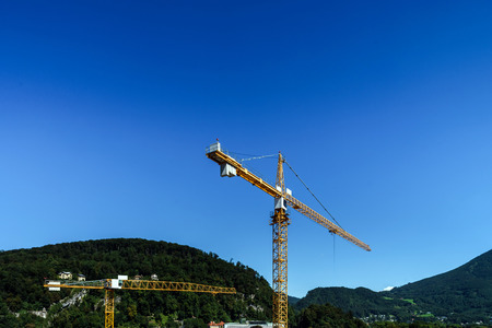 Big crane over the city on blue sky background, Salzburg, Austriaの写真素材