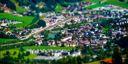 Tilt-shift aerial view of little austrian city in the valley, Austria, summerの写真素材