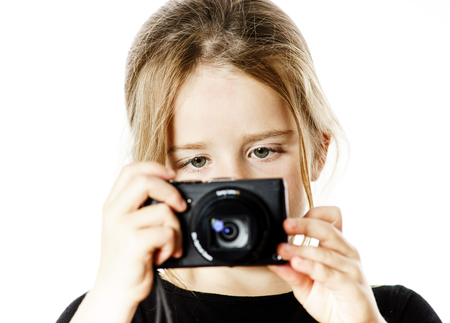 Cute little girl with compact digital camera, isolated on white backgroundの写真素材