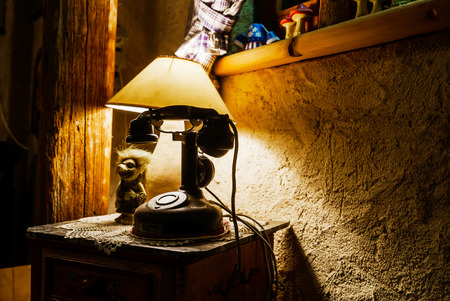 Vintage telephone and old lamp in retro style, eveningの写真素材