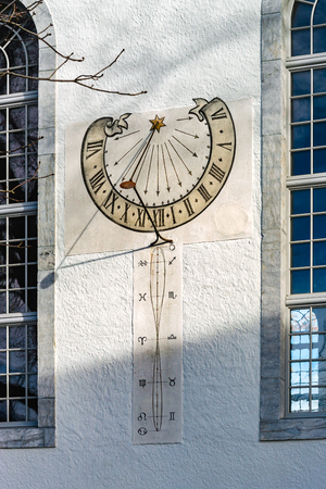 Old sun clock on the wall of church, Thun, Switzerlandの写真素材