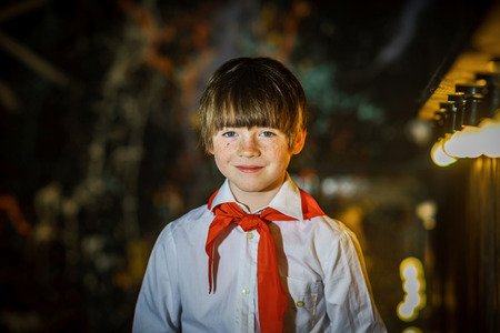 Redhead attractive boy dressed like soviet pioneer with red tie, studioの写真素材