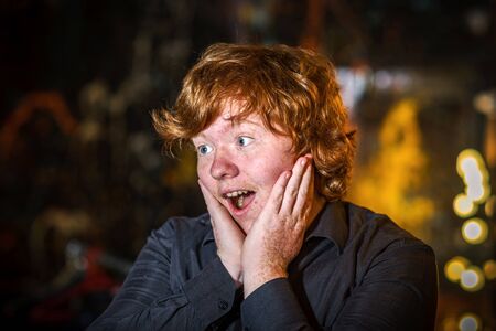 Teenage red-haired freckled boy showing wonderingの写真素材