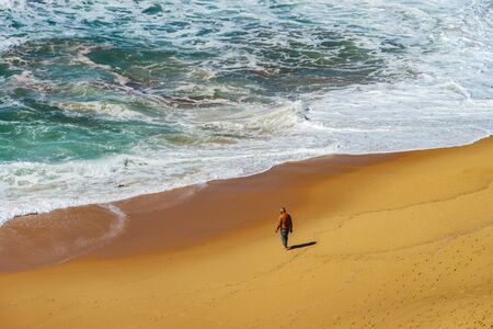 Vivid yellow sand and rocks on coastline, Portugal, aerial viewの写真素材