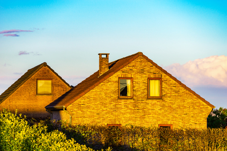 Beautiful old house with garden in Belgium, sunset timeの写真素材