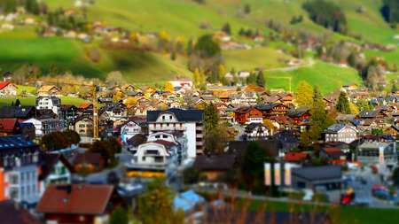 Green hills in swiss valley tilt shift view, sunny day, Chateau-dOex, Switzerland
