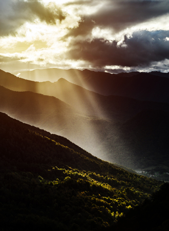 Sun rays lighting through the clouds in high Pyrenees, France