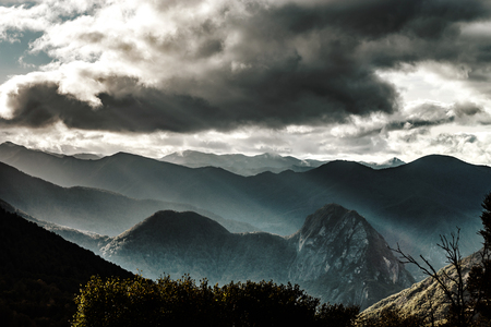 Sun rays lighting through the clouds in high Pyrenees, Franceの写真素材