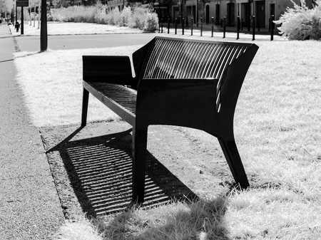 New metal bench on bright sunlight in public park along the river, Auxerre, Franceの写真素材
