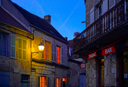 Evening time in old french city Vezelay. Light of old-styled street lantern.. France.のeditorial素材