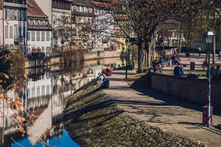 Editorial: 27th February 2019: Strasbourg, France. First sunny days in old quarter Little France. People on the sun.のeditorial素材