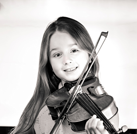 Cute emotive little girl with violin, music and educational concept, isolated on whiteの写真素材