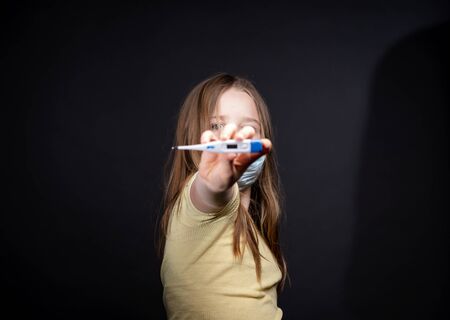 Girl in a medical protective mask. Coronavirus epidemic. Conceptual image. Symbol. Stop the virus. Protective equipment.の写真素材