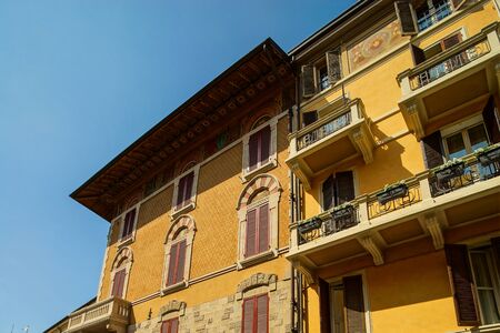 Bright and colorful Italian cityscape. Sunlit streets. Colorful houses. Warm and comfortable. Tourism and travel. The sea, palm trees and ancient shutters on all windows and balconies.の写真素材