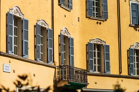 Bright and colorful Italian cityscape. Sunlit streets. Colorful houses. Warm and comfortable. Tourism and travel. The sea, palm trees and ancient shutters on all windows and balconies.の写真素材