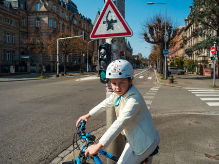 Strasbourg / France : March 27th 2020:  Quarantine time. Coronavirus epidemic. Girl on a bicycle in the empty city of Strasbourg.のeditorial素材