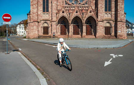 Strasbourg / France : March 27th 2020:  Quarantine time. Coronavirus epidemic. Girl on a bicycle in the empty city of Strasbourg.のeditorial素材