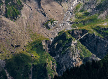 Terrible lifeless rocks, a glacier in the Alps, clouds and fog spread over the peaks of the mountains. Switzerlandの写真素材