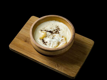 Dumplings in a pot, cooked in Russian, in the oven.Isolated on black background.