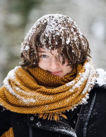 Young girl in a snowy forest. Plays with fresh snow. Snow falls from the trees directly on itself....
