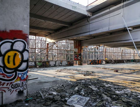 Editorial: 7th March 2021: Strasbourg, France. Old factory buildings. Ruin. The walls are painted with graffiti, broken glass on the floor, the roof is full of holes.のeditorial素材