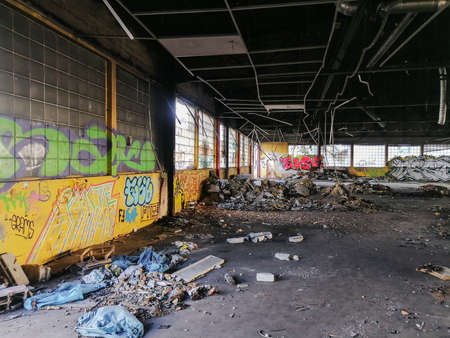 Editorial: 7th March 2021: Strasbourg, France. Old factory buildings. Ruin. The walls are painted with graffiti, broken glass on the floor, the roof is full of holes.のeditorial素材