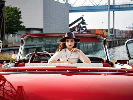 60-s oldtimer red Cadillac and a beautiful young girl. France.の写真素材