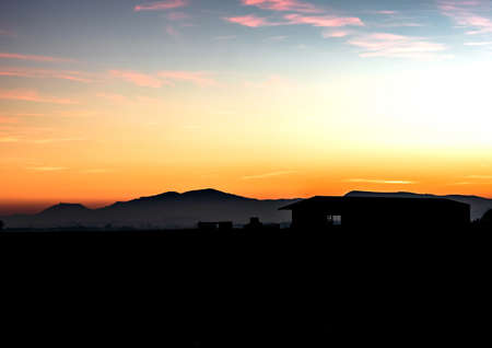 Silhouettes of mountains against the backdrop of a colorful beautiful amazing sunset in Alsaceの写真素材