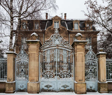 An old manor with beautiful gates is covered with snow. Strasbourgのeditorial素材