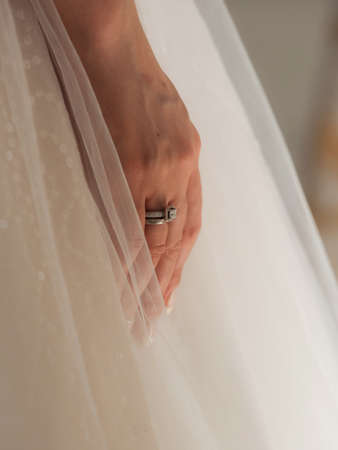 Delicate details of the wedding celebration. Newlyweds hold hands. Flowers and decor.の写真素材