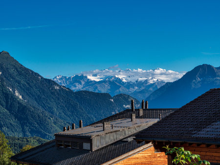 Alpine Swiss Village. Comfort and tranquility. A sunny summer day. Flowers on the windows. Wooden chalets.の写真素材